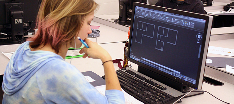 A CAD student works at her computer.