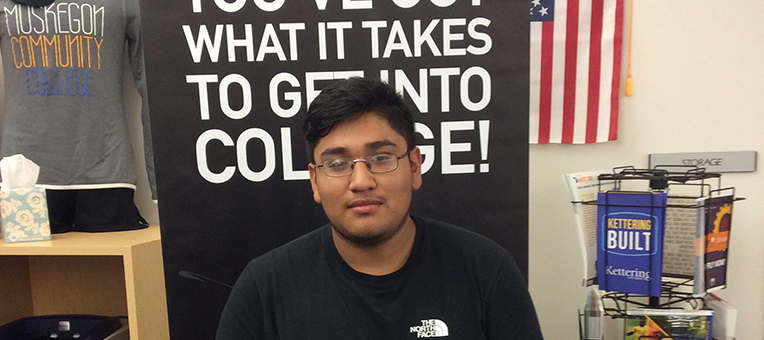 A teenage young man completes his college application.