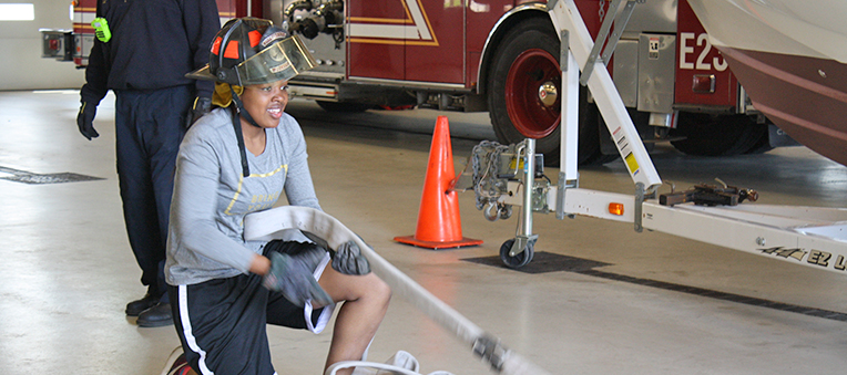 A Criminal Justice student practices fire fighting drills.
