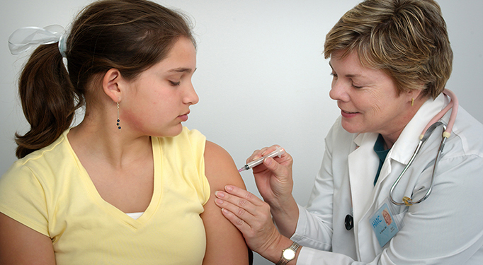 Young girl receiving a vaccine shot