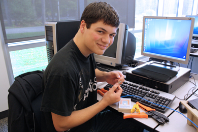 Internet, Network, & Security Technologies student working on making cables.