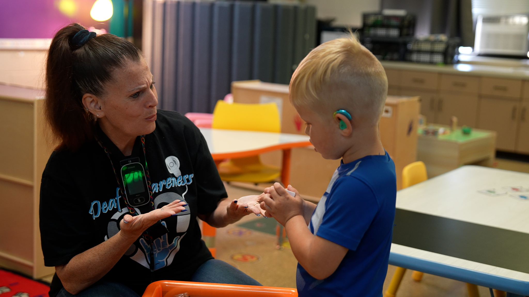 A teacher working with a student