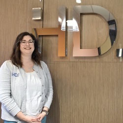 Julianne Johnson in front of HDJ sign