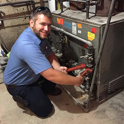 Former HVACR student Andy Klein performing a repair