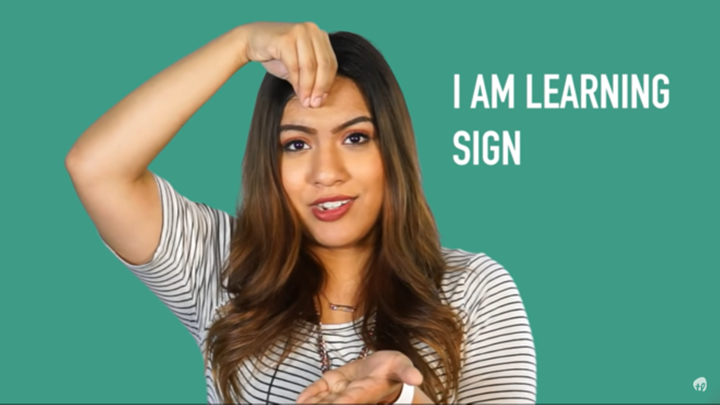 Woman demonstrating the A S L phrase 