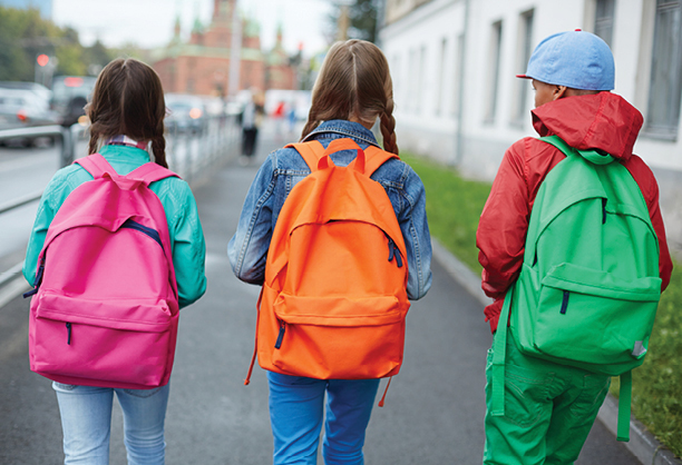 THRIVE_Homepage Three kids with colorful backpacks walking to school