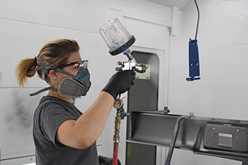 Auto Collision/Refinishing student working in paint booth.