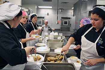 Culinary students working together in the kitchen.