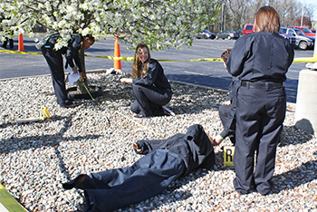 Criminal Justice students assessing mock crime scene.