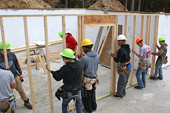Construction Trade students setting a wall.