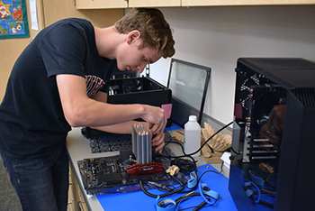 An Internet, Network & Security Technologies student assembling a gaming computer