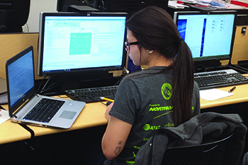 An Internet, Network & Security Technologies student works on solving a cyber security issue during a Cyber Patriots competition