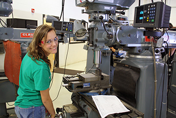 Machining/Engineering Tech student operating a mill machine.
