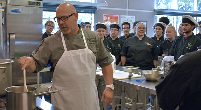 A Sullivan University representative working with Hospitality & Food Management students