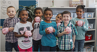 Kids in Classroom with piggy banks