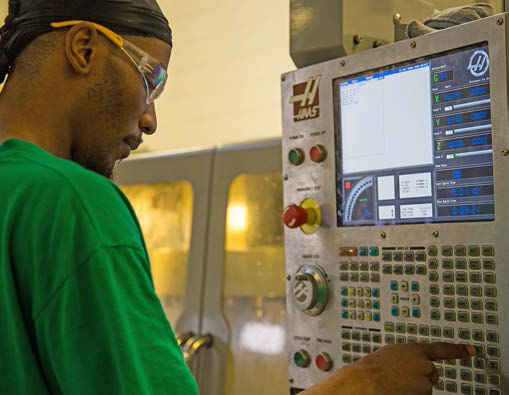 CNC Machinist working at the controls