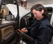 Female mechanic using digital diagnostics