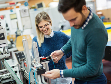 Employee showing job shadow student manufacturing work