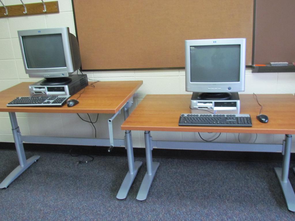 computers on desks showing tables of different heights