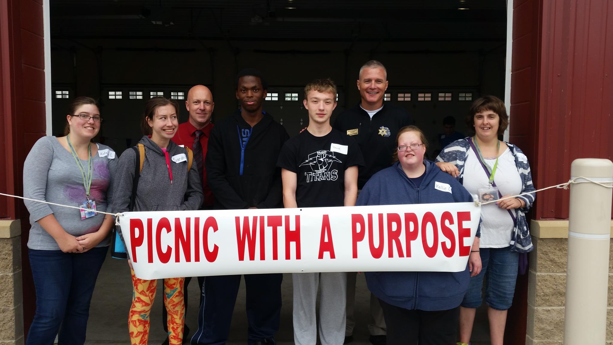 eight students holding picnic sign